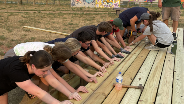 Students on the 2021 South Dakota Mission Trip work on assembling a stage. 
